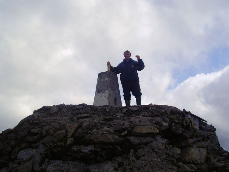 Neil at the Ben Nevis summit with Ben Nevis single malt whisky