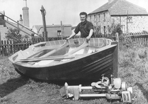 William shows off a dinghy he has built in the back yard of 28 Seafield Street